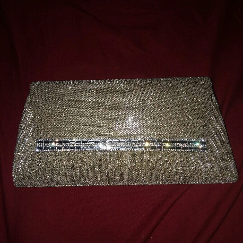 A shiny gold colored cloth clutch